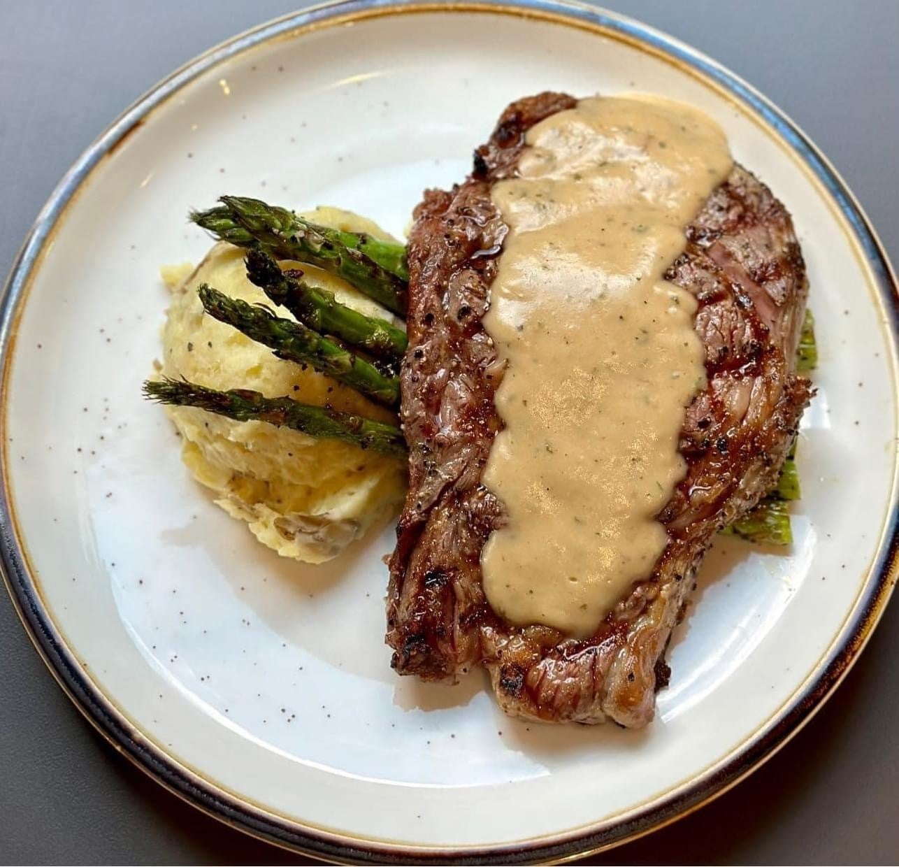 16oz Ribeye w/ au poivre and 2 sides Oink Inc Smokehouse